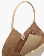 Hand-made mini shopper, made with woven leather bands, with double tubular handles embellished with small studs and adjustable and removable leather watch.

The bag is equipped with a comfortable removable leather clutch.
Microfiber inner lining and accessories with gold finish.

Material: Calfskin
Dimensions: 15x24x10 cm