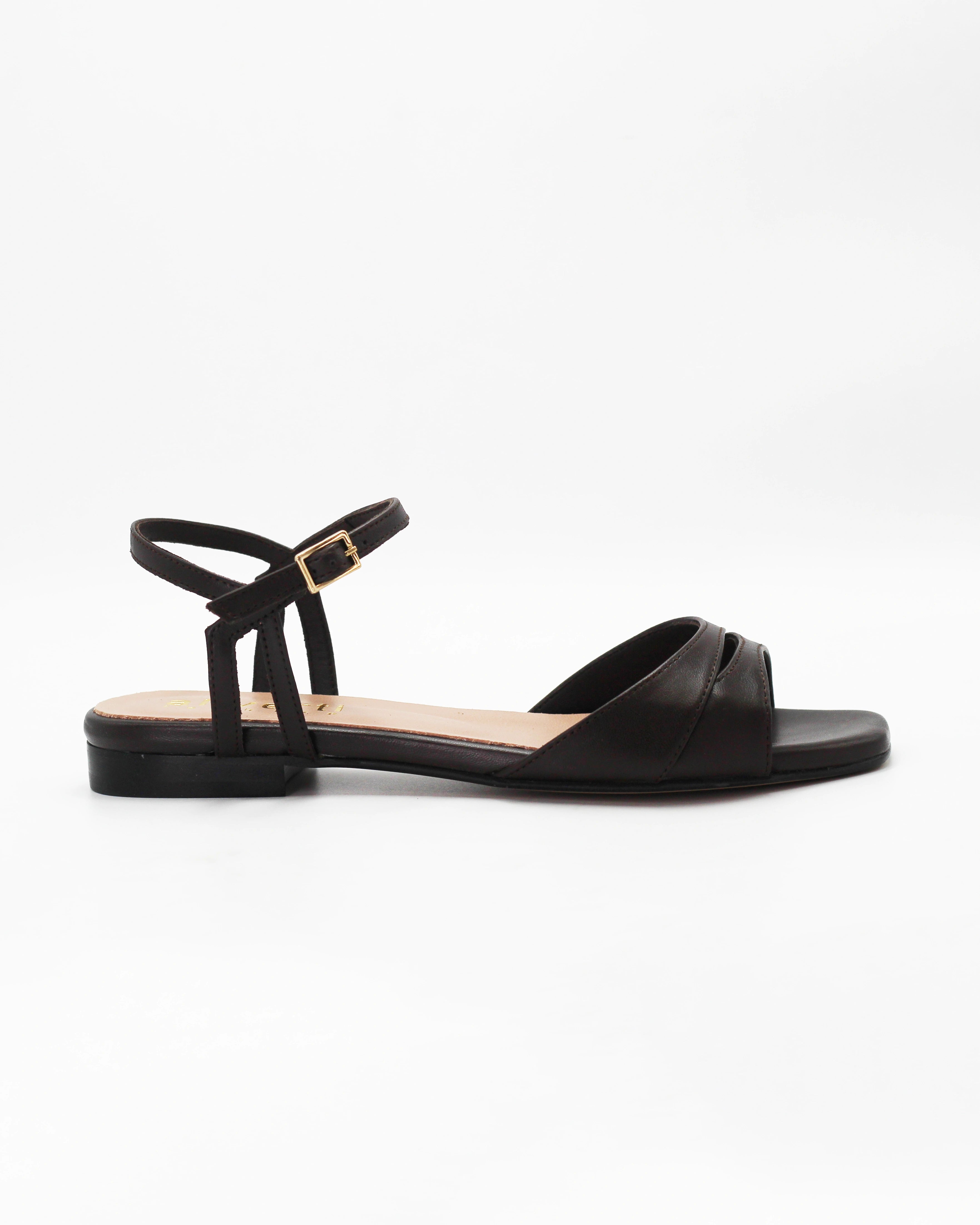 PATTY26 flat two-strap sandal in testa di moro calf leather with a soft cut-out toe strap and adjustable ankle strap. Handcrafted in Italy. Easy everyday wear.