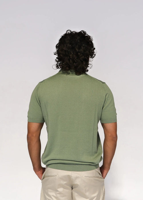 Sage green knit polo shirt with short sleeves and a two-button placket, styled with beige trousers — Aliverti Italian menswear, Cape Town.