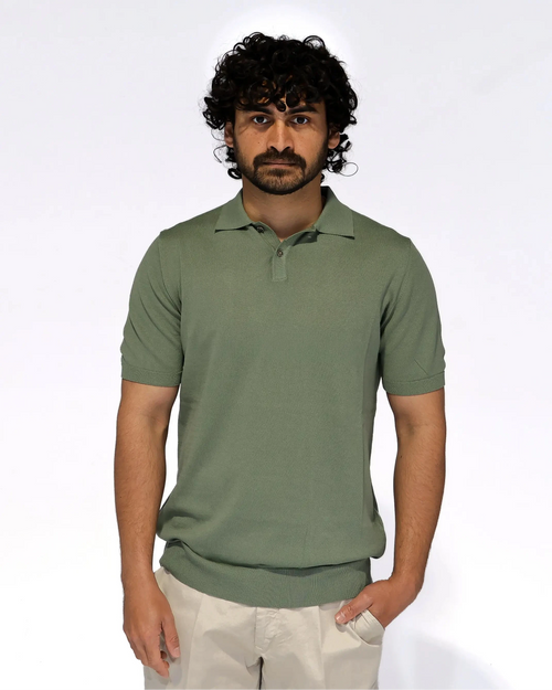 Sage green knit polo shirt with short sleeves and a two-button placket, styled with beige trousers — Aliverti Italian menswear, Cape Town.